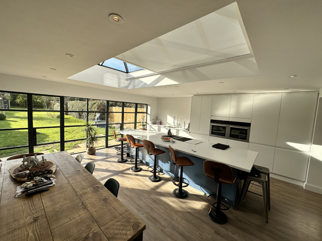 Modern kitchen with large 2m x 4m skylight above island, fitted with Athena electric roof blind.