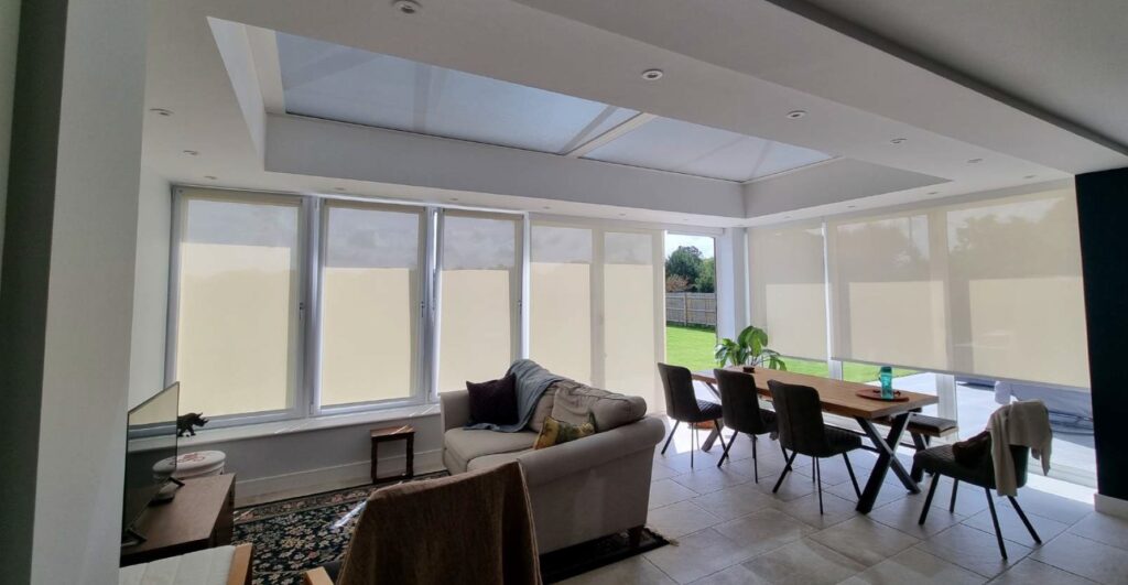 Fully glazed extension with roof lantern, bifold doors, and tilt-and-turn windows fitted with electric blinds.