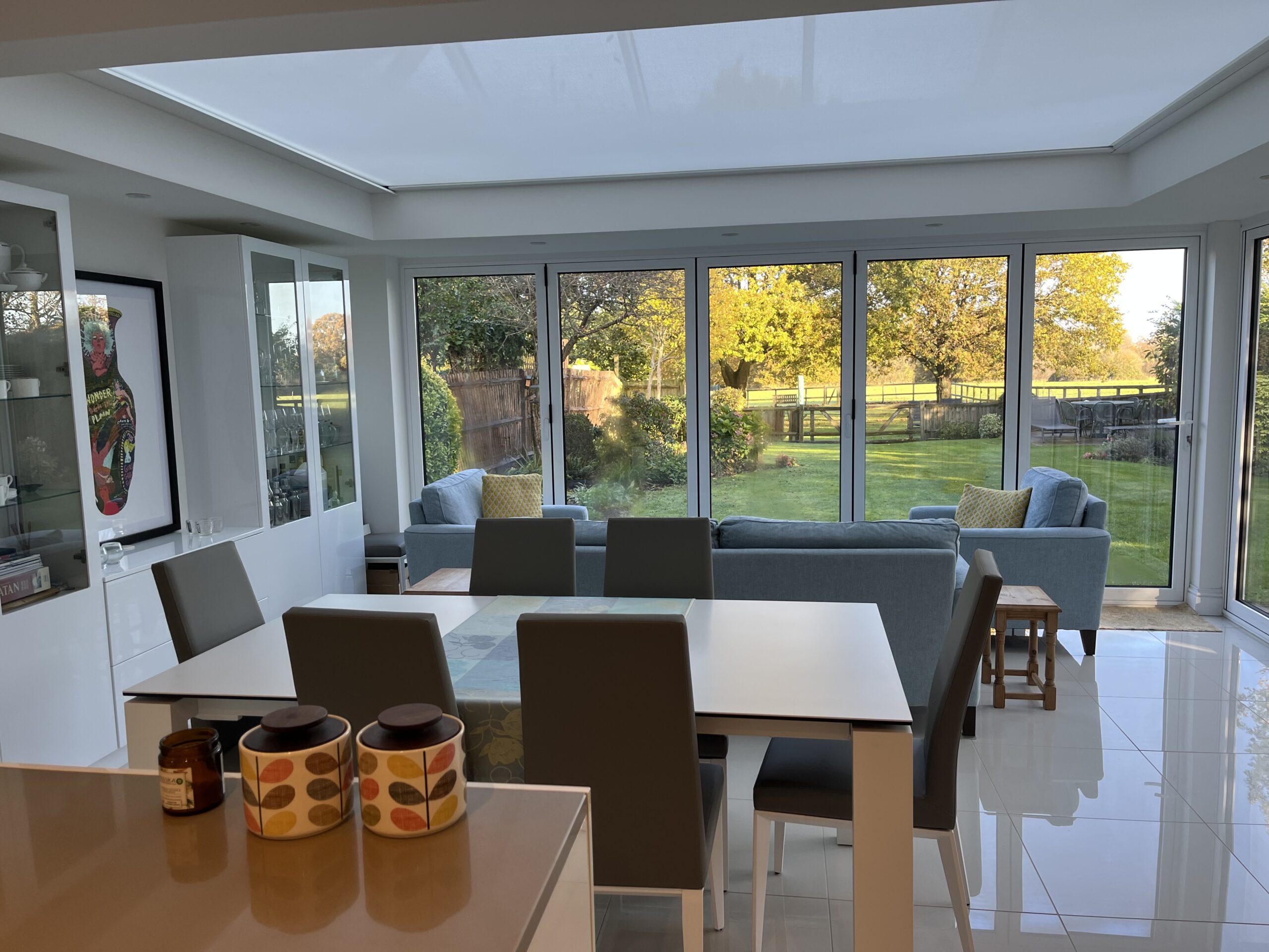 Large Hercules roof blind with flat fabric and powerful tension system installed in glazed extension.