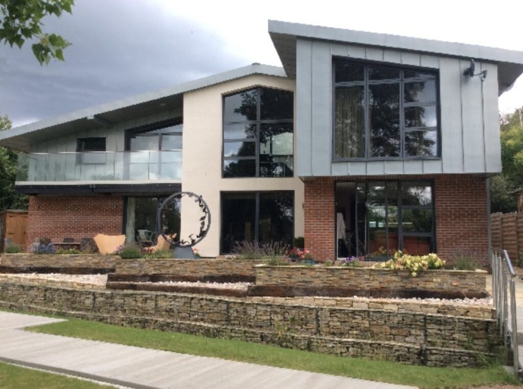 Modern two‑storey home with large glass windows fitted with a mix of 3M Prestige 40 and 70 Exterior films, balancing solar heat rejection and natural light.