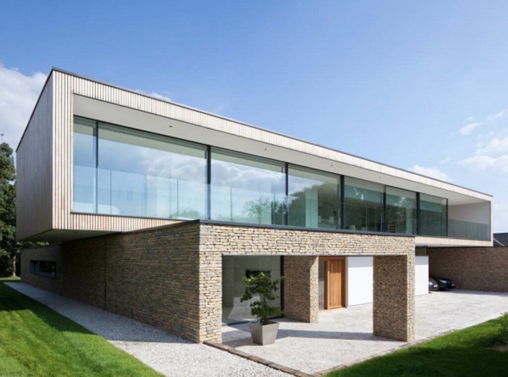 Modern two-story home with large sliding glass doors; 3M Prestige 70 window film applied to reduce heat gain without altering appearance.