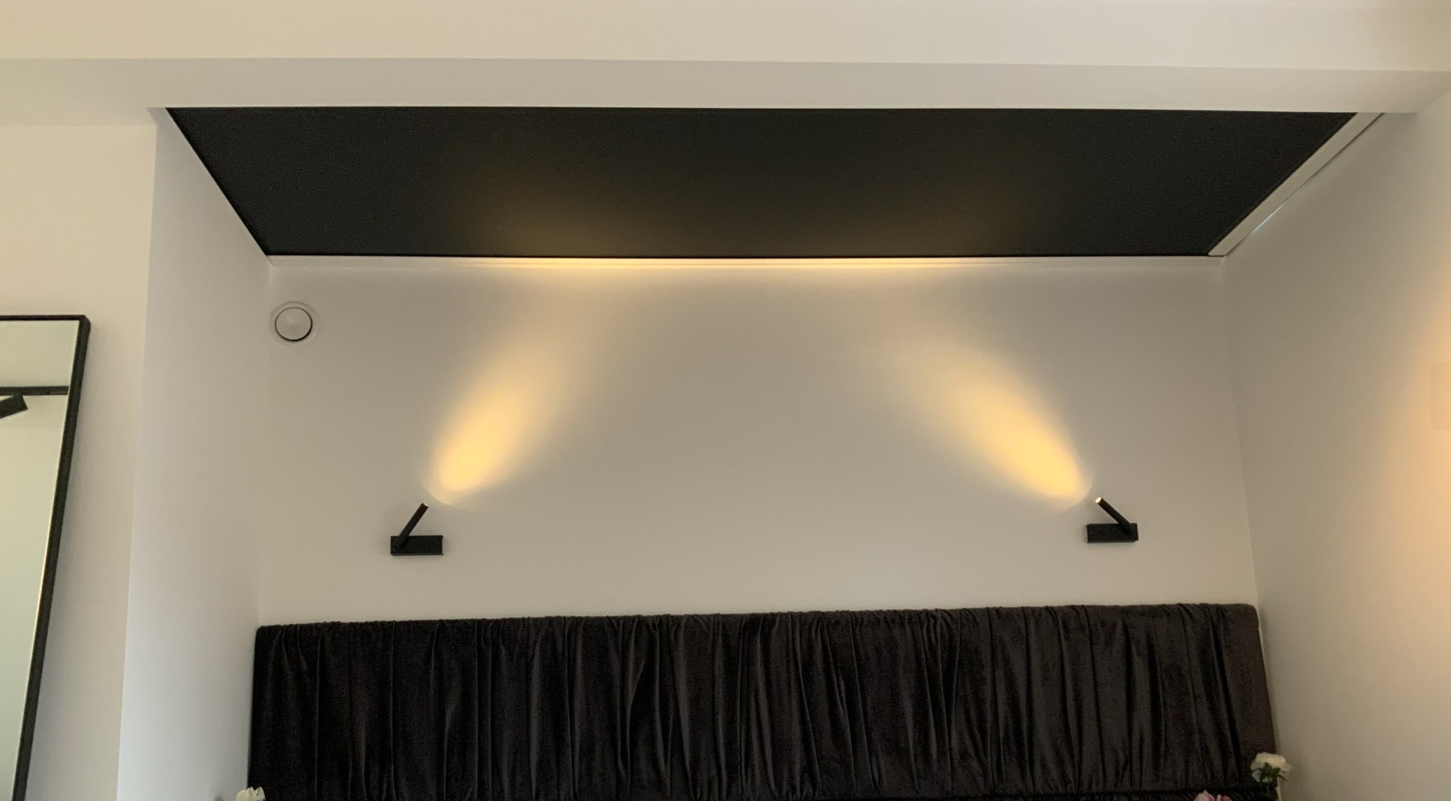 Master bedroom wall with concealed skylight blind system designed to preserve an uninterrupted night‑sky view while providing blackout and insulation when needed.