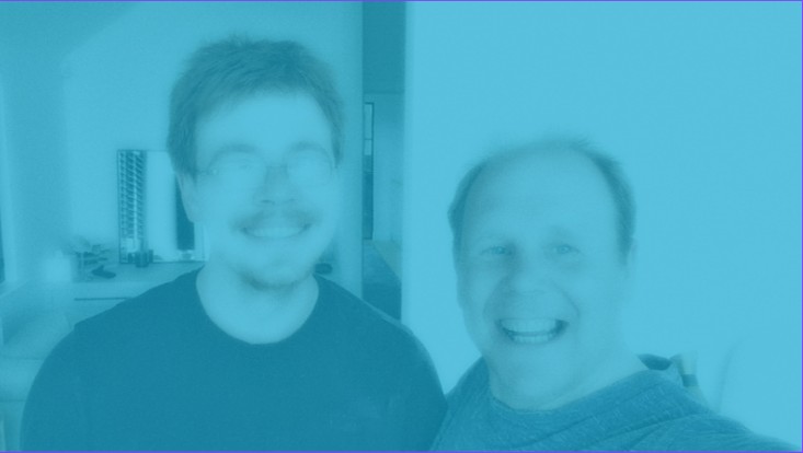 Two members of our installation team smiling indoors, representing our expert survey and installation service for electric blinds and awnings.