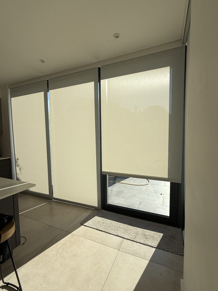 Electric roller blinds filtering strong sunlight in Caroline and Mike’s new extension, reducing heat and glare while keeping the room bright.