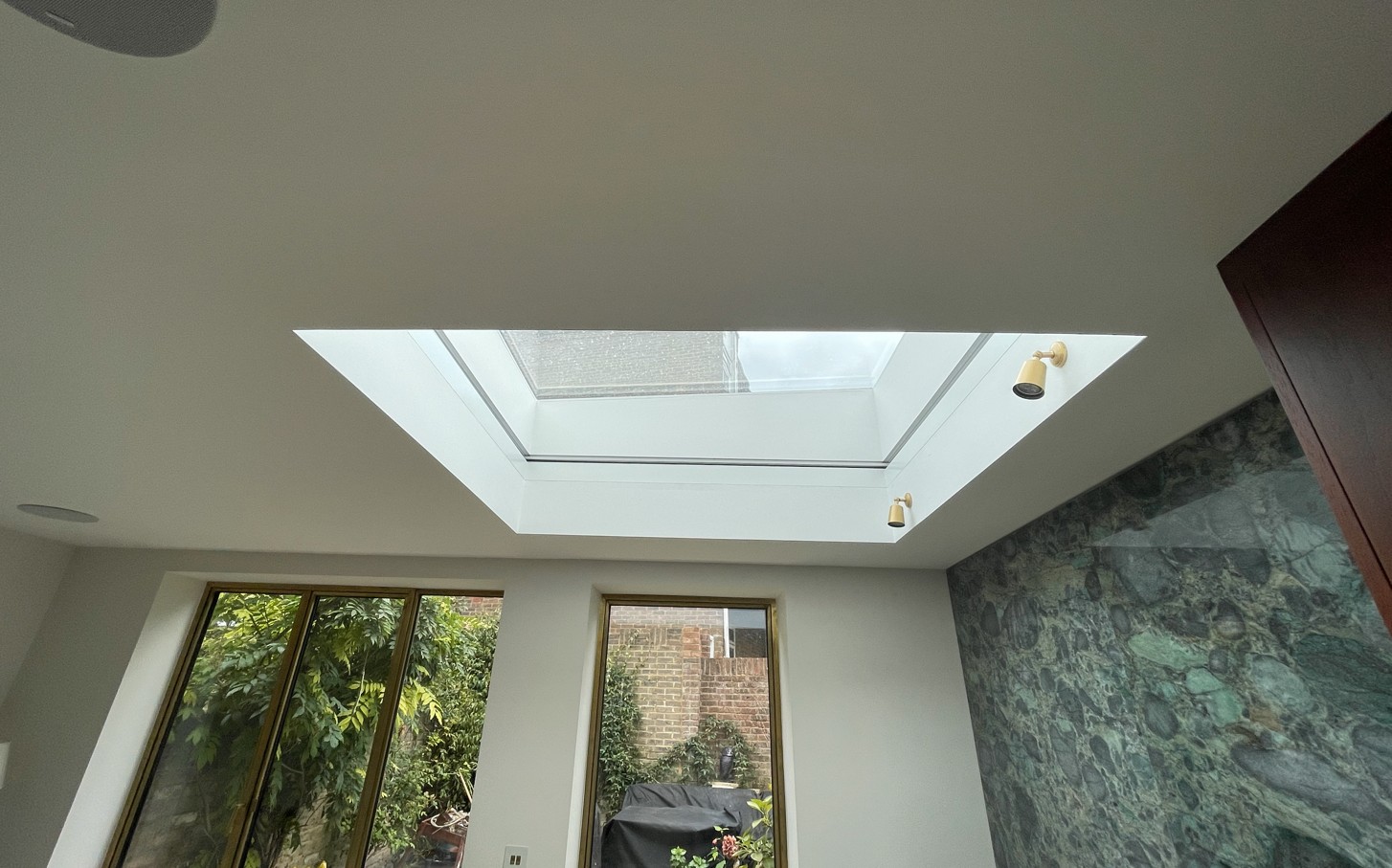 A large skylight with the Blindspace roof blind fully retracted and hidden within the ceiling