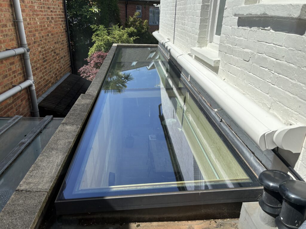 Three closed cassette awnings sit retracted above Janice’s overhead side return glazing.