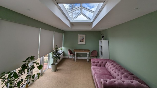 Blackout blinds emerging from concealed Blindspace boxes in Rupert and Kitty’s extension, partially covering the roof lantern and side glazing.