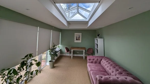 Blackout blinds emerging from concealed Blindspace boxes in Rupert and Kitty’s extension, partially covering the roof lantern and side glazing.